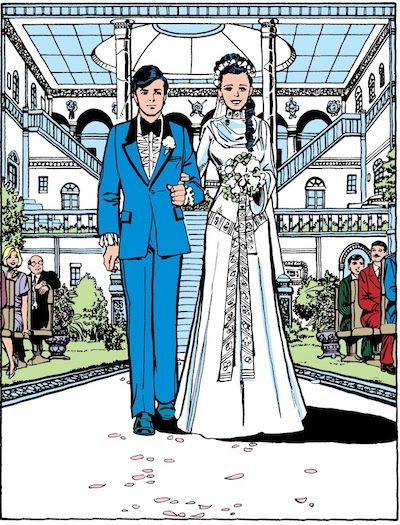 One panel from Tales of the Teen Titans #50. Dick walks Donna down the aisle at her wedding. She is wearing a white gown with long sleeves. He is wearing a bright blue tux with black trim and a very ruffly white shirt.