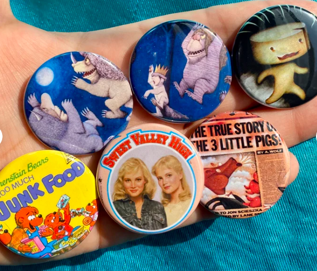 Six pin-back buttons with images from Where the Wild Things Are, The Stinky Cheese Man, The Bearenstain Bears, and Sweet Valley High