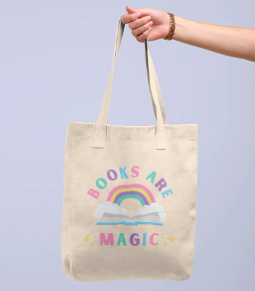 Tote bag with a pastel colored screenprint of a rainbow and the phrase "Books are magic"