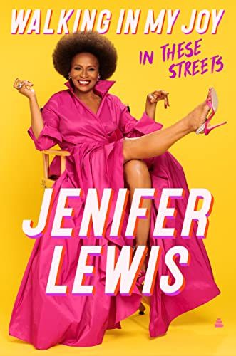 cover of Walking in My Joy: In These Streets by Jenifer Lewis; photo of the author, a Black woman, in a bright pink dress and heels with one leg kicked up