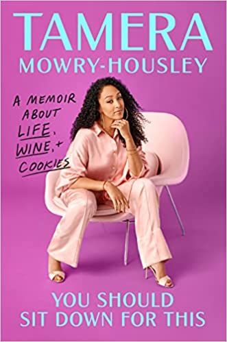 cover of You Should Sit Down for This: A Memoir about Life, Wine, and Cookies by Tamera Mowry-Housley; photo of the author, a Black woman, in a light pink pantsuit sitting in a matching chair