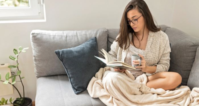 Image of a person reading on a couch