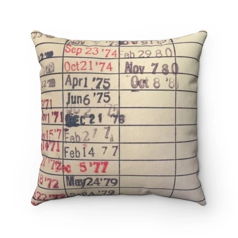 Photo of a square pillow with a print of a library card.