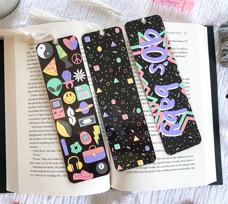 Image of three black bookmarks with pastel 90s images on them. 