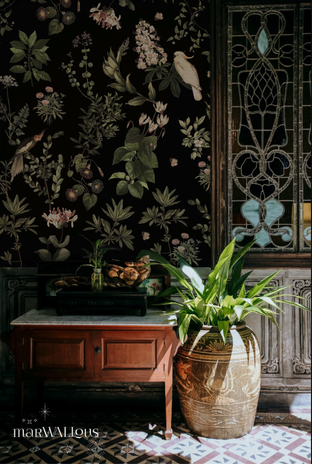 dark botanical wallpaper with a stained glass window, a nightstand, and a potted plant in front of it
