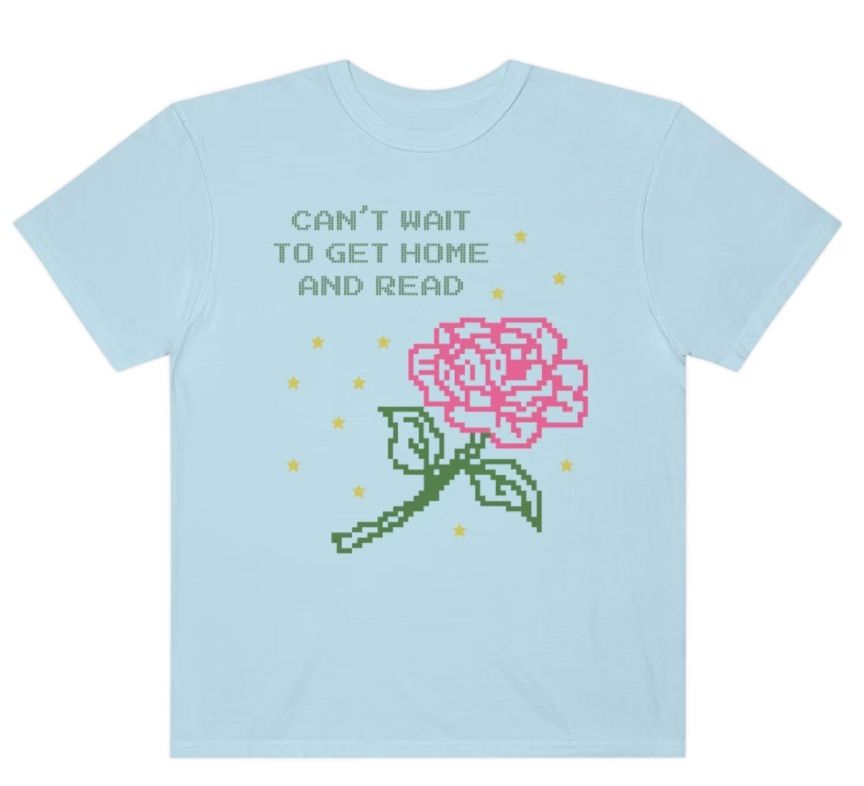 Image of a blue shirt with pixelated words that say "can't wait to get home and read," with a pixilated rose image. 