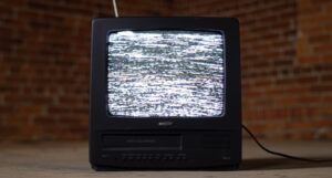 an old analog cable television displaying white noise