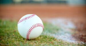 a baseball on grass in a baseball diamond