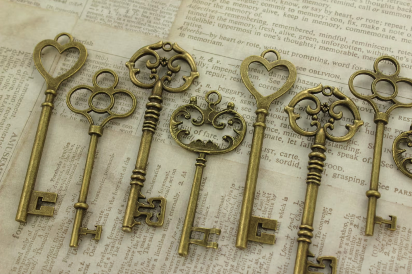 ornate brass skeleton keys laid on top of a book page