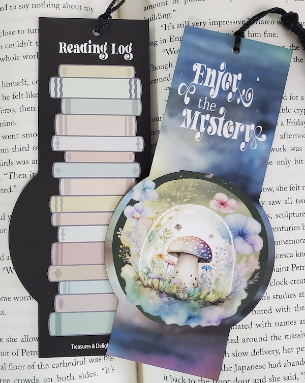 an illustrated bookmark with a pretty mushroom design on one side that says "enjoy the mystery" and the back is a reading log by TreasuresDelightsetc