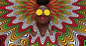 the cropped cover of No Edges, with psychedelic waves of colors radiating out from an illustration of a Black person wearing yellow flower sunglasses