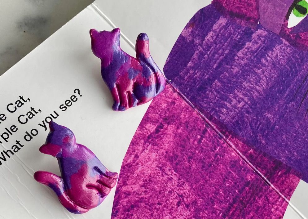 Image of purple cat stud earrings.