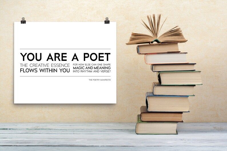 You Are A Poet print next to a stack of books