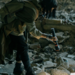 a photo of someone searching rubble with a flashlight