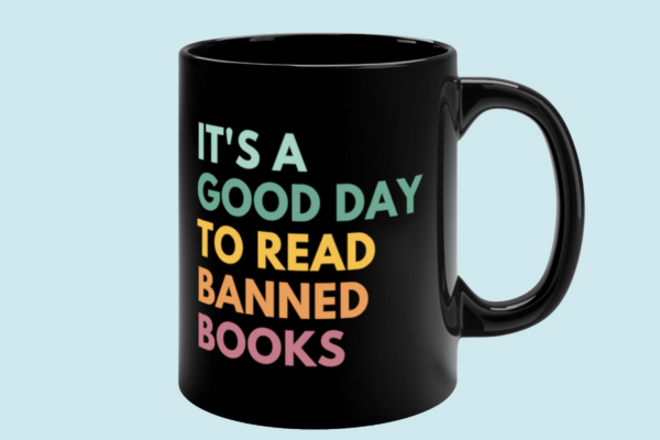 Black mug with colorful text reading "It's a good day to read banned books"