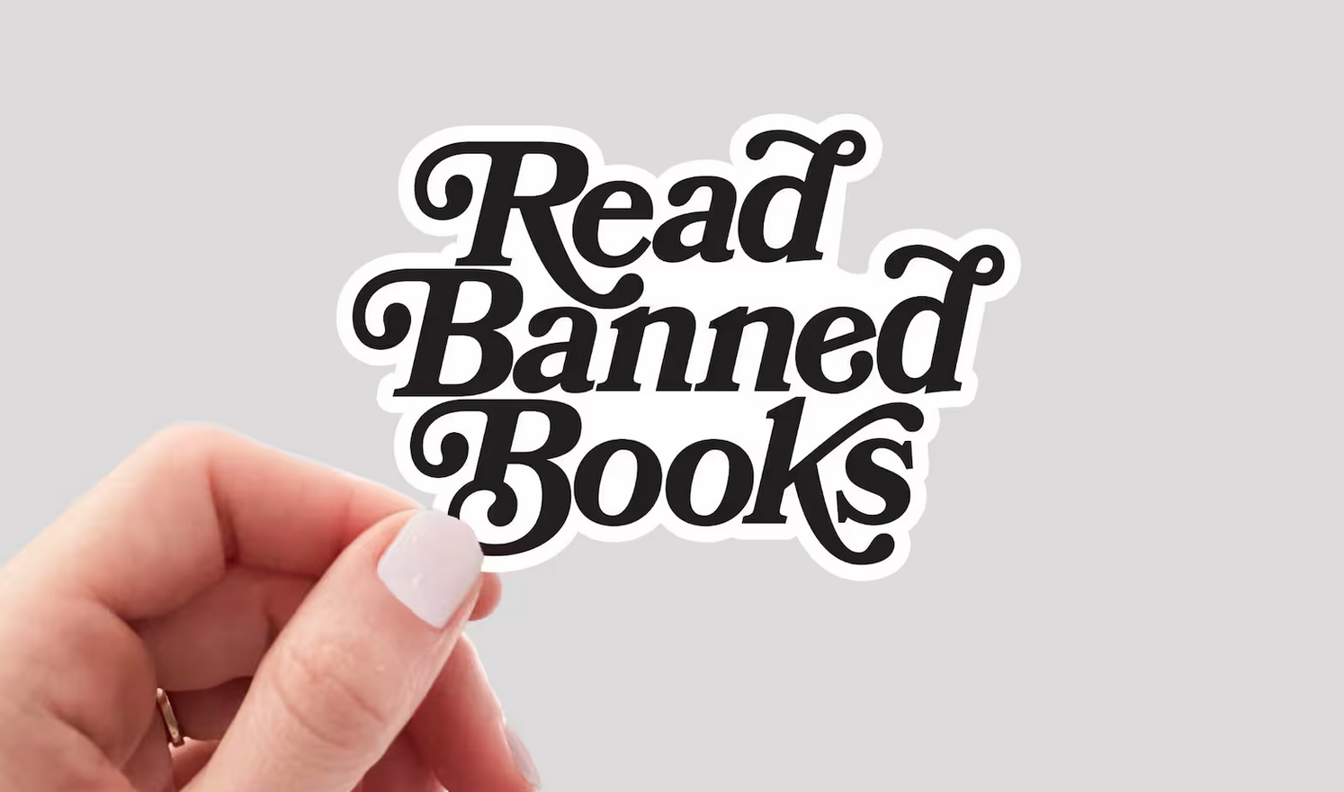 white sticker with black text saying "read banned books"
