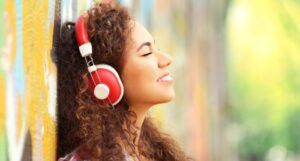 Image of a person listening to headphones outside