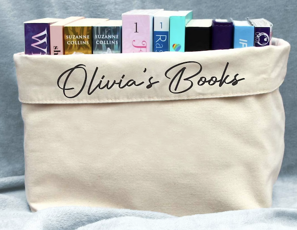 an open, rectangular cloth bag filled with books