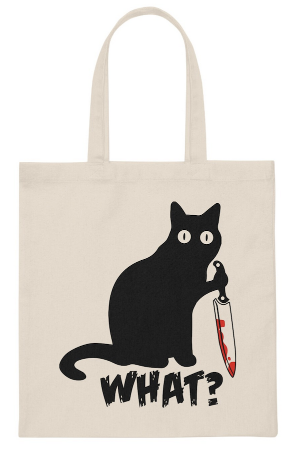canvas tote bag with a screen print image of a black cat holding a bloody knife with text saying "what?"