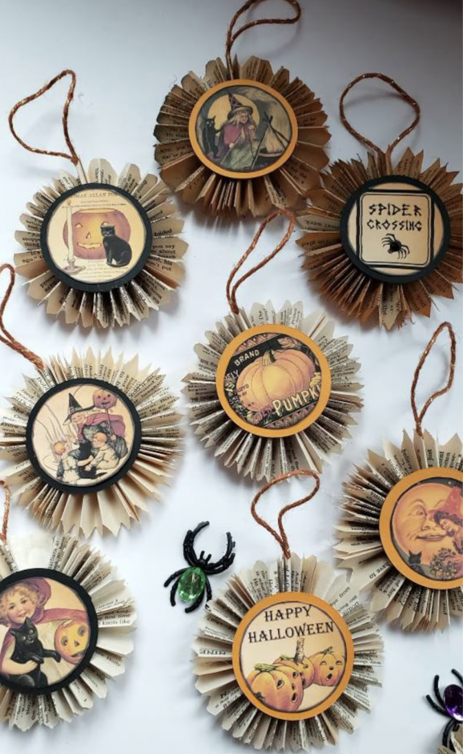 Ornaments made with round cutouts of vintage Halloween images of witches and ghosts with folded ruffle collars made from book pages