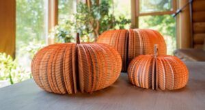 Orange pumpkin decor made out of book pages spray painted orange