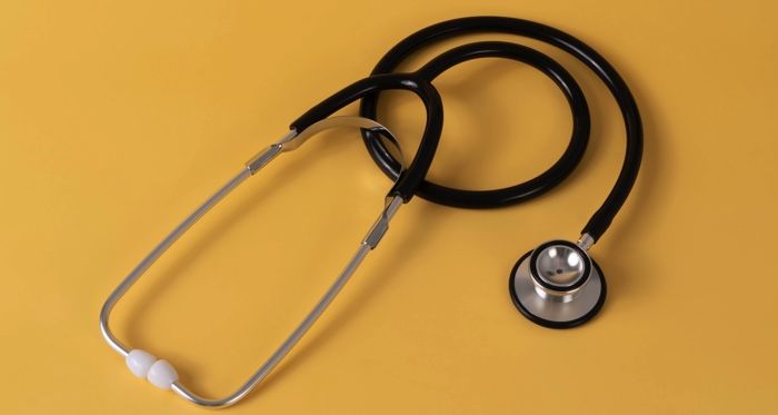 stethoscope against a yellow background