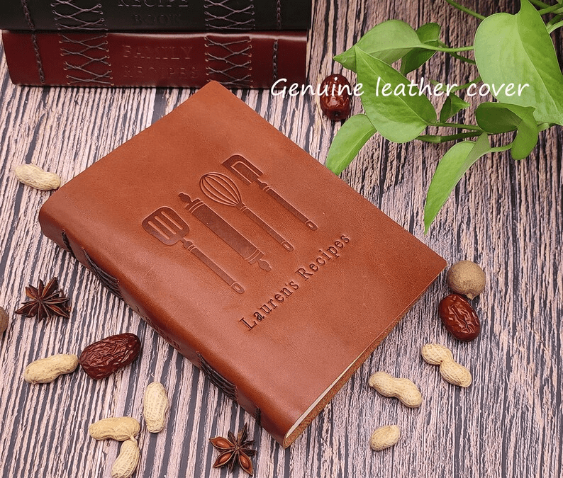 Photo of a leather notebook with kitchen tools and text engraved on the cover