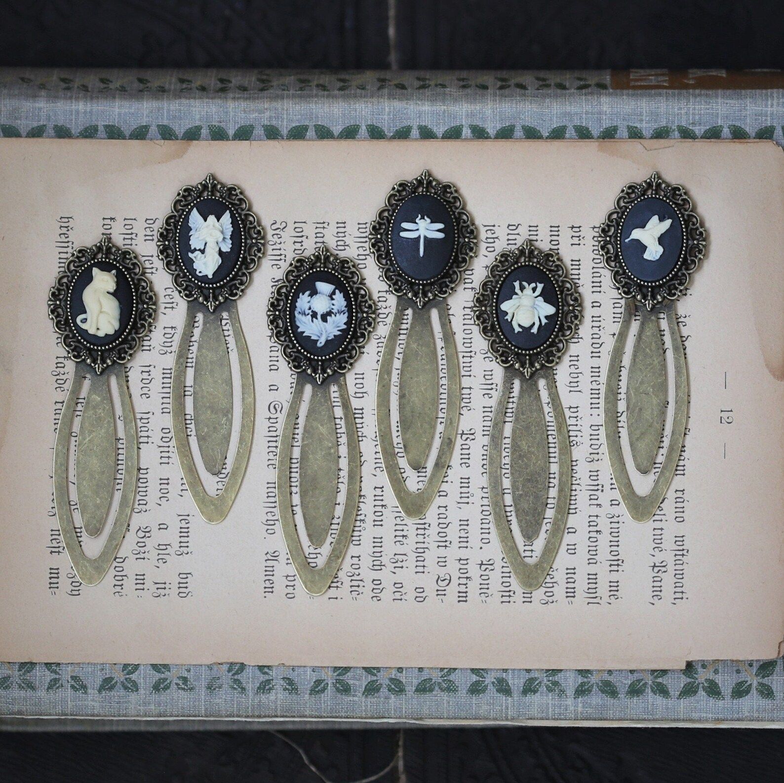 metal bookmarks with black and white cameos at the end