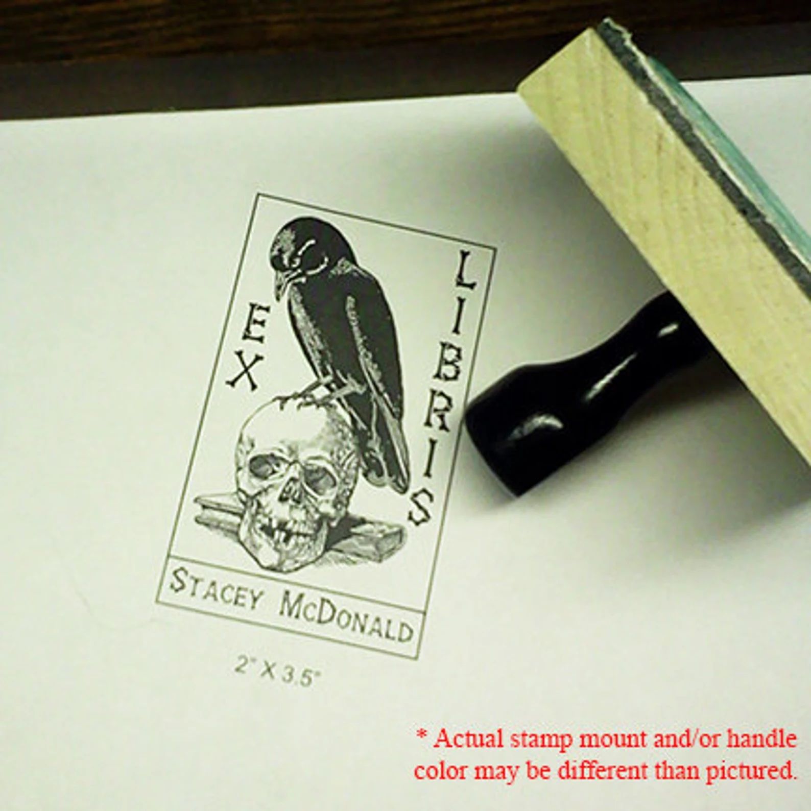 an ex libris stamp of a raven on a skull