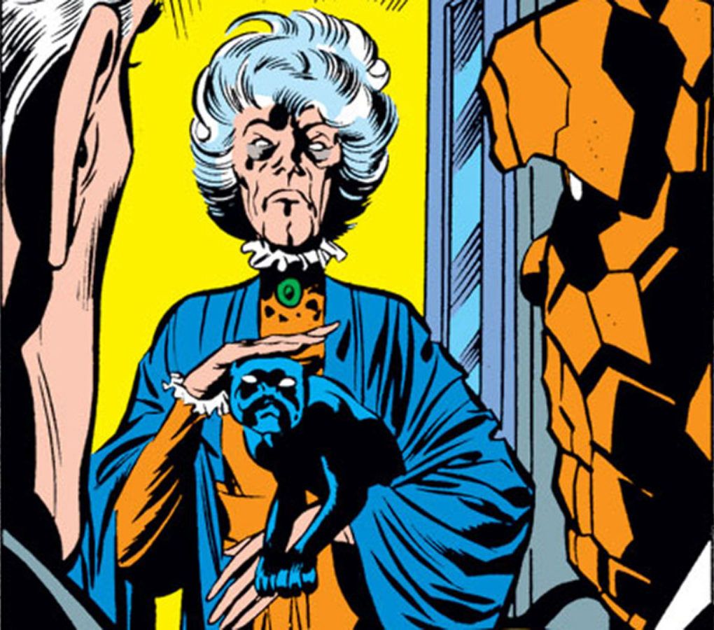 a Fantastic Four comics panel with a white-haired old woman, Agatha Harkness, frowning and petting a black cat
