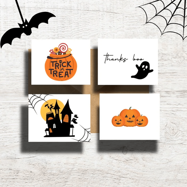 Photo of four notepads one with a pumpkin shaped candy basket with the text trick or treat, one with the text Thanks boo and a ghost, one a haunted house and one with three pumpkins. 