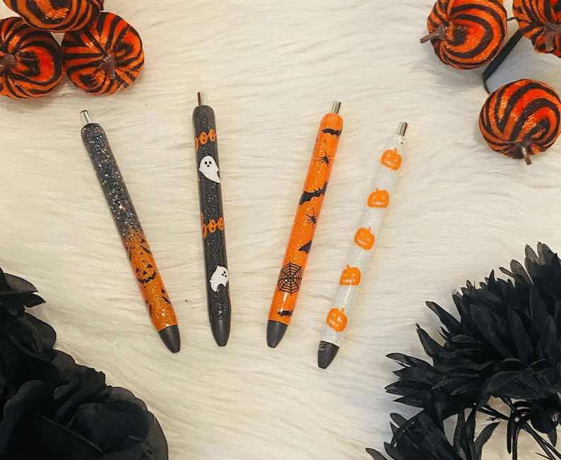 Photo of four Halloween themed pens placed on a table.
