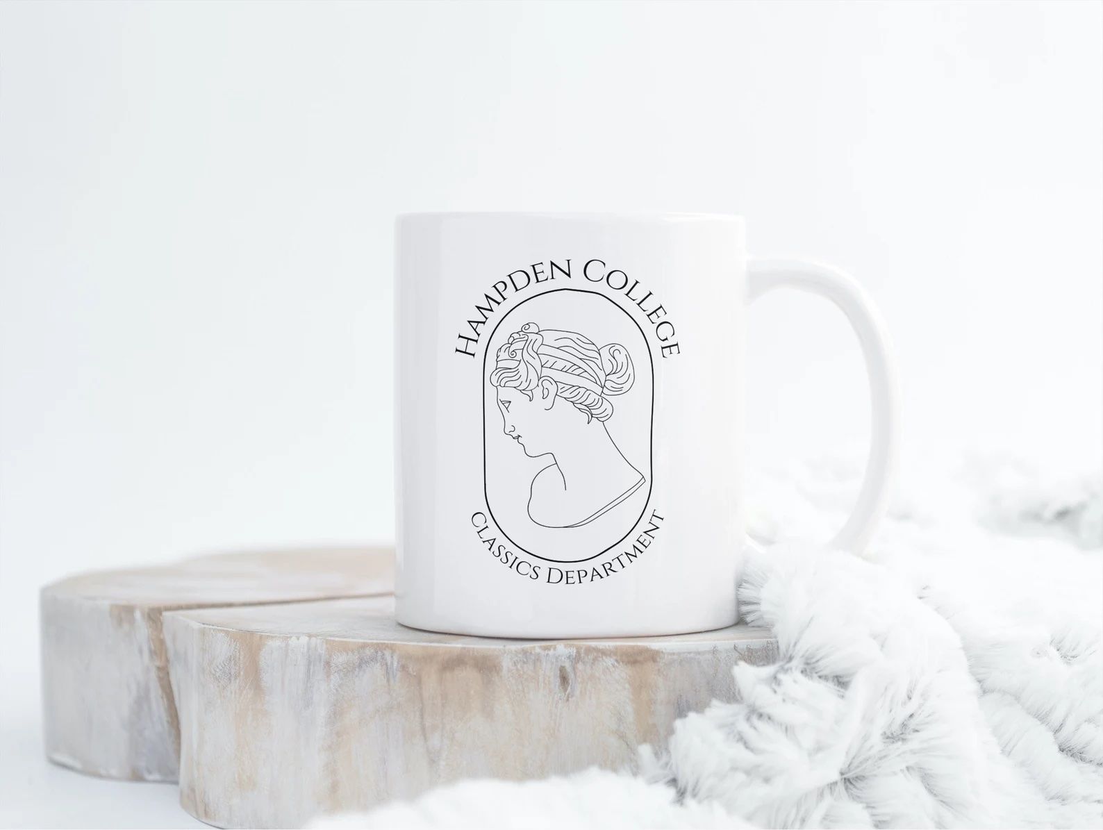 white coffee mug with hampden college logo