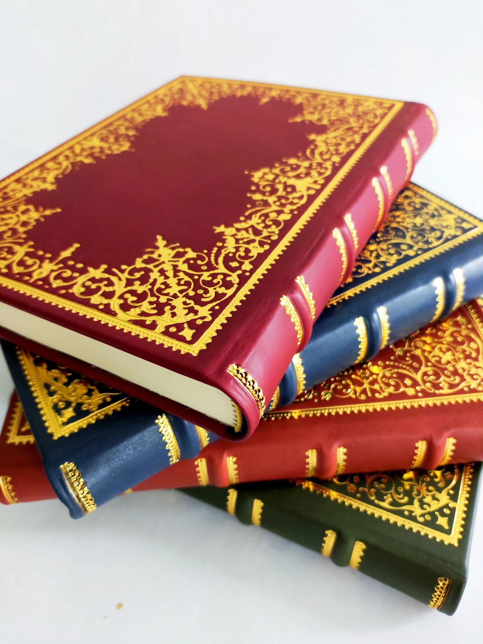 stack of leatherbound journals with gold details