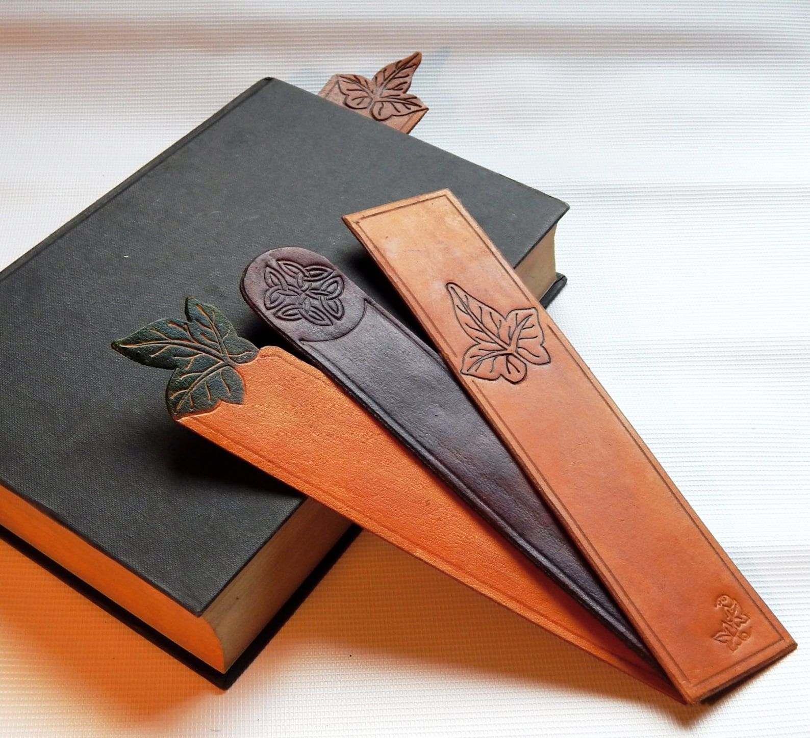 A set of three leather bookmarks embossed with leaves