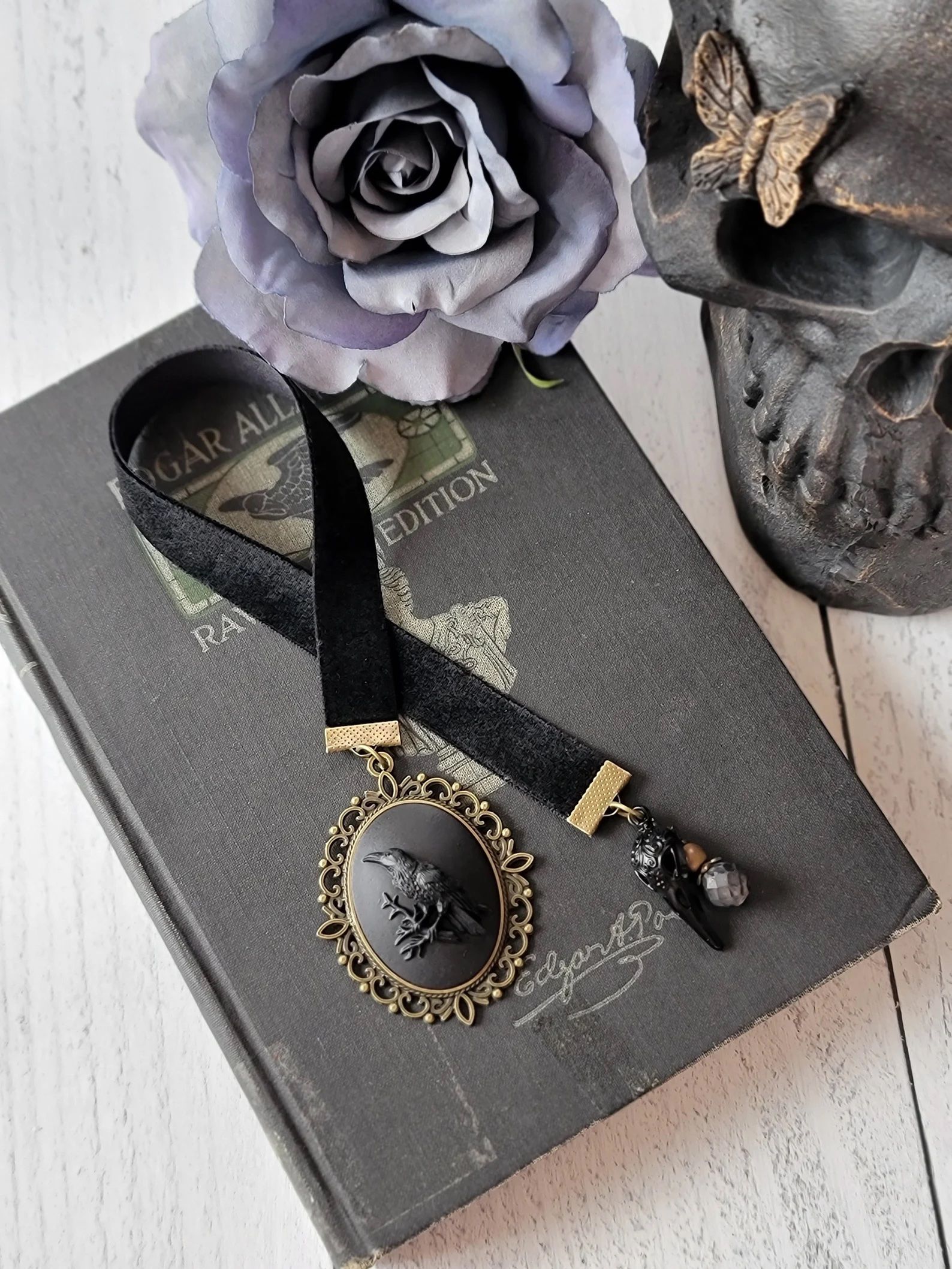 a ribbon bookmark with a raven cameo at the end