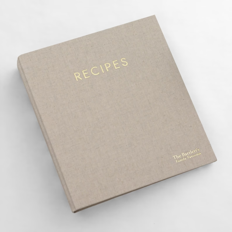 Photo of a simple recipe notebook in beige with the word RECIPES at the centre