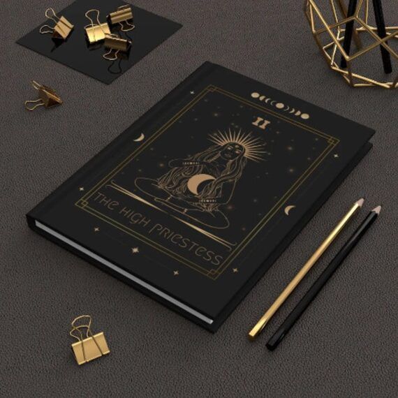 black hardcover journal with golden tarot design