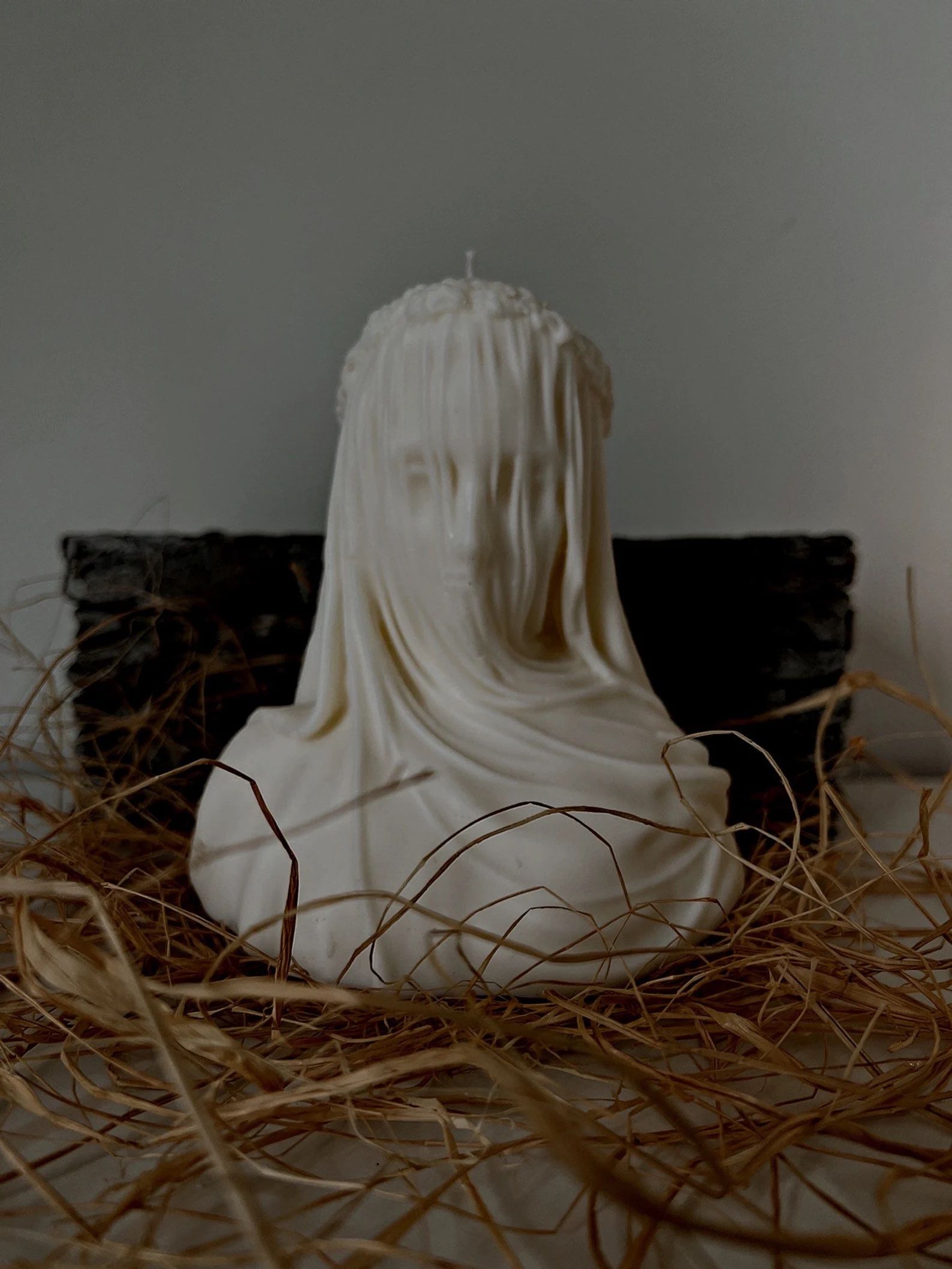 a candle version of the veiled lady sculpture