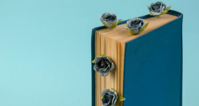 a photo of a book with flowers sticking out between the pages