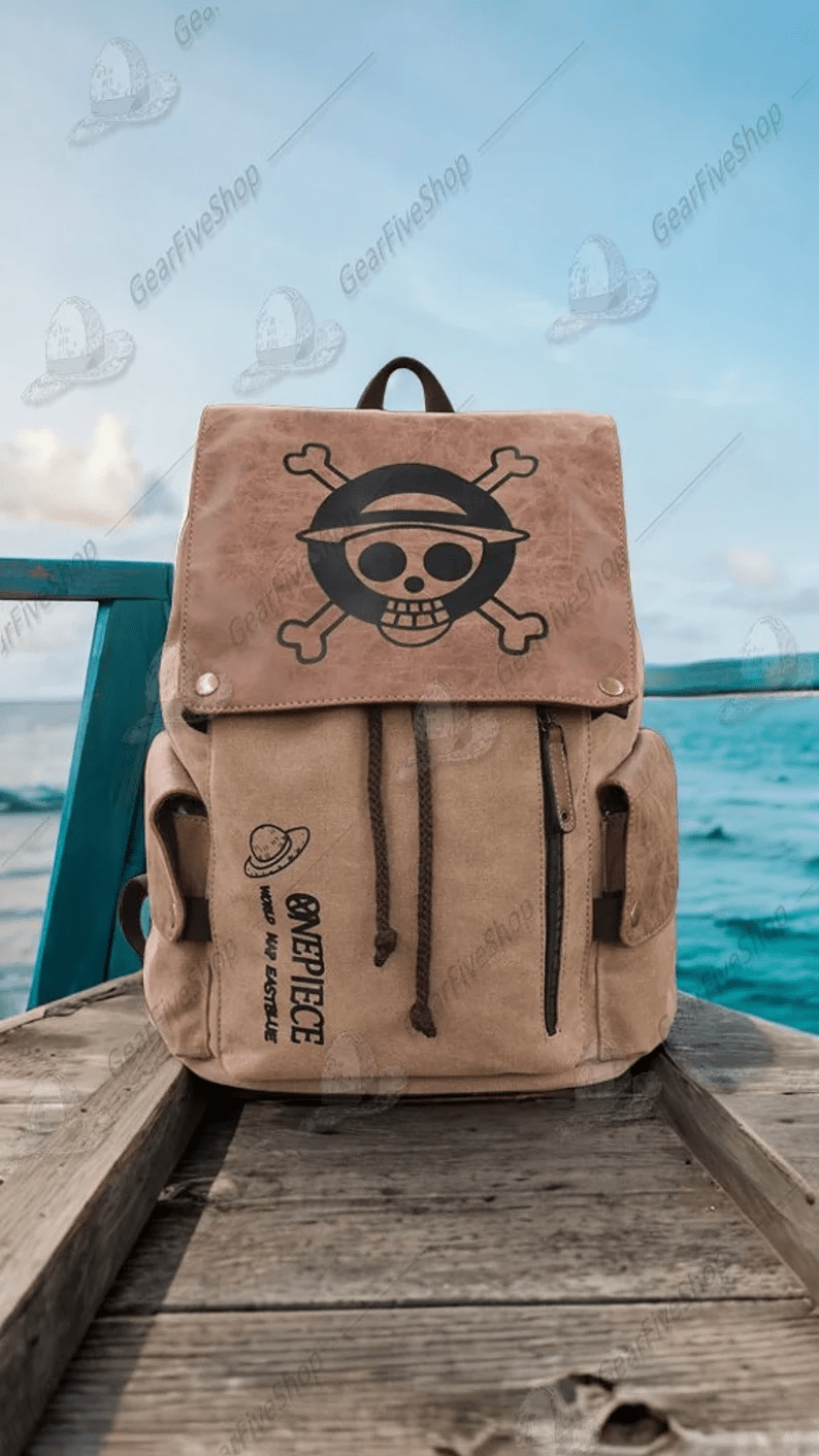 Photo of a beige backpack with the One Piece symbol printed on the top flap. 
