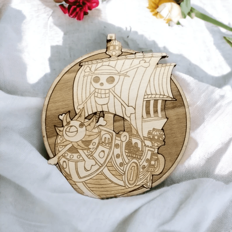 Photo of a wooden coaster with a very detailed carving of the One Piece ship.