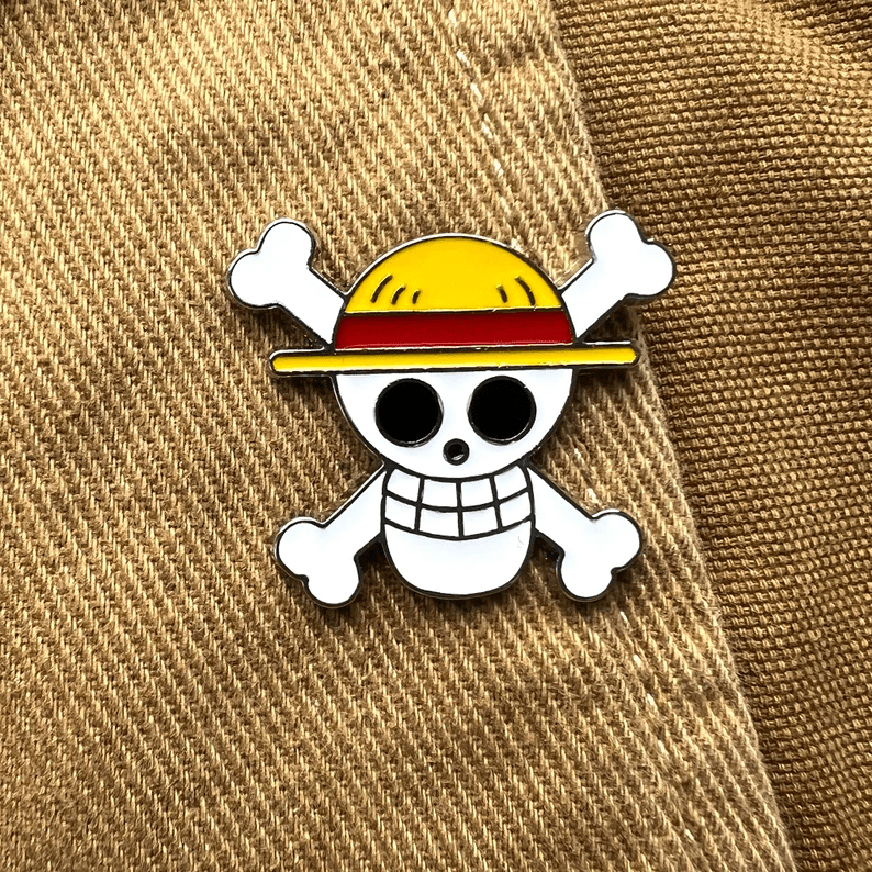 Photo of a One Piece skull shaped pin.