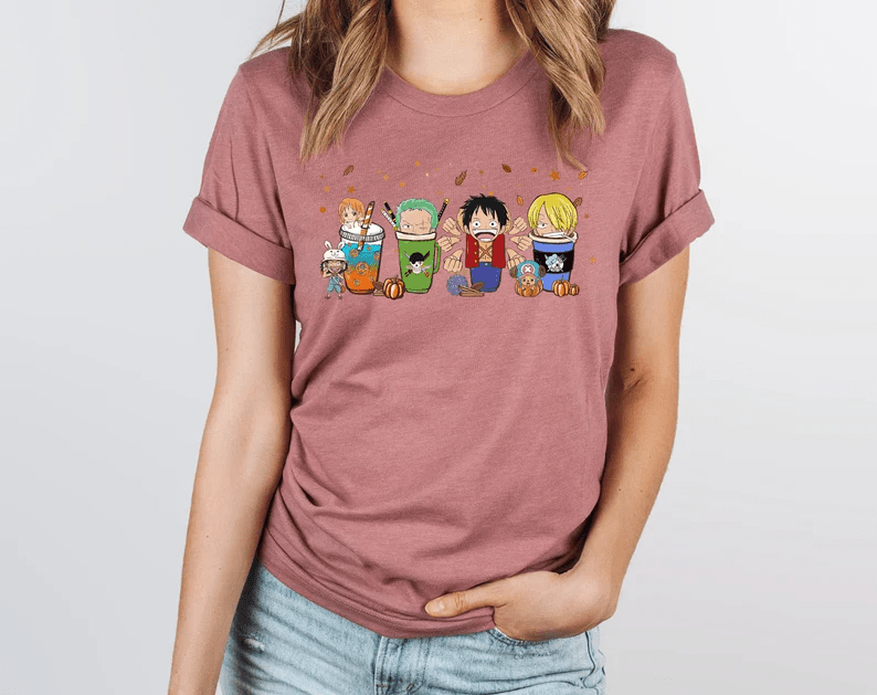 Photo of a woman wearing a pin t-shirt with some of One Piece characters with coffee and tea mugs.