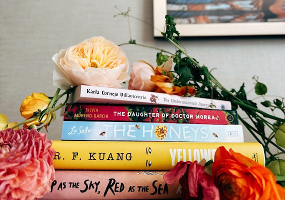 Stack of books with flowers draped on it