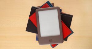 Image of an ereader on top of a stack of books