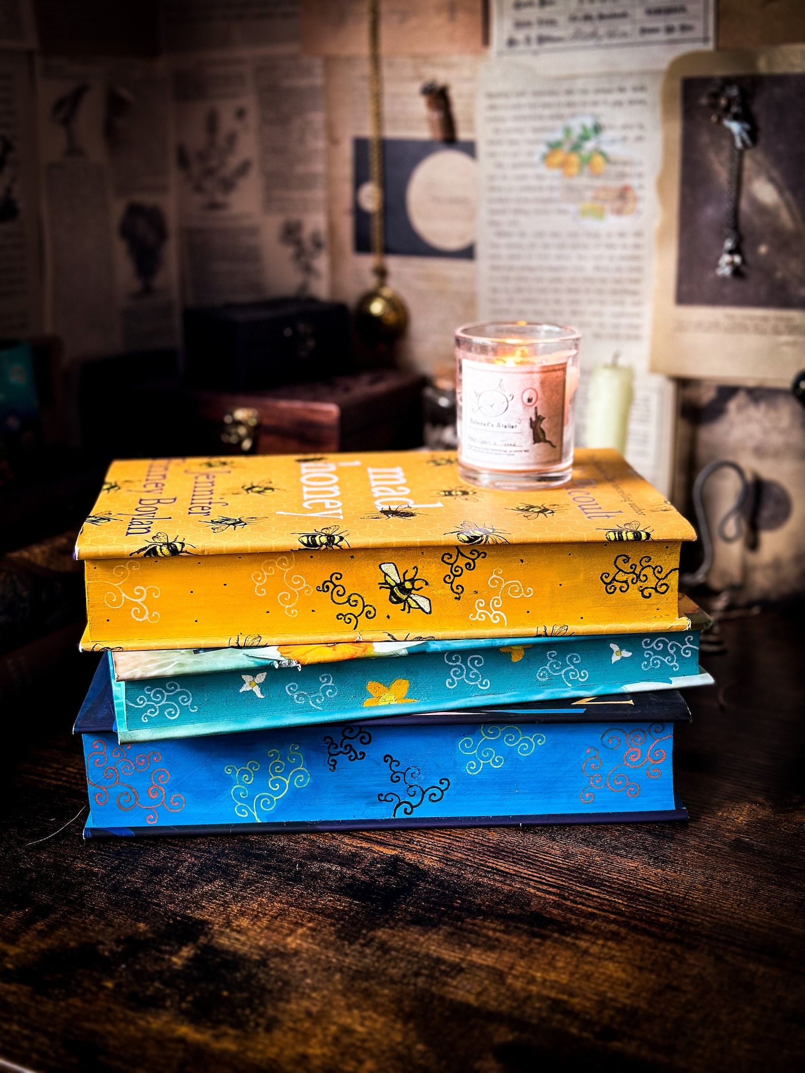 Three books with painted edges in a stack.