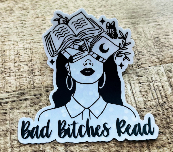 illustrated sticker of woman with books covering her eyes and head and text saying "bad bitches read"