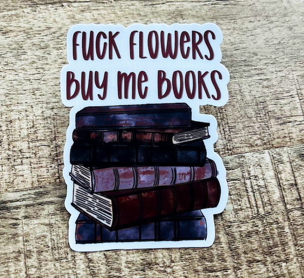 illustrated sticker of a stack of books with text that says "fuck flowers buy me books"