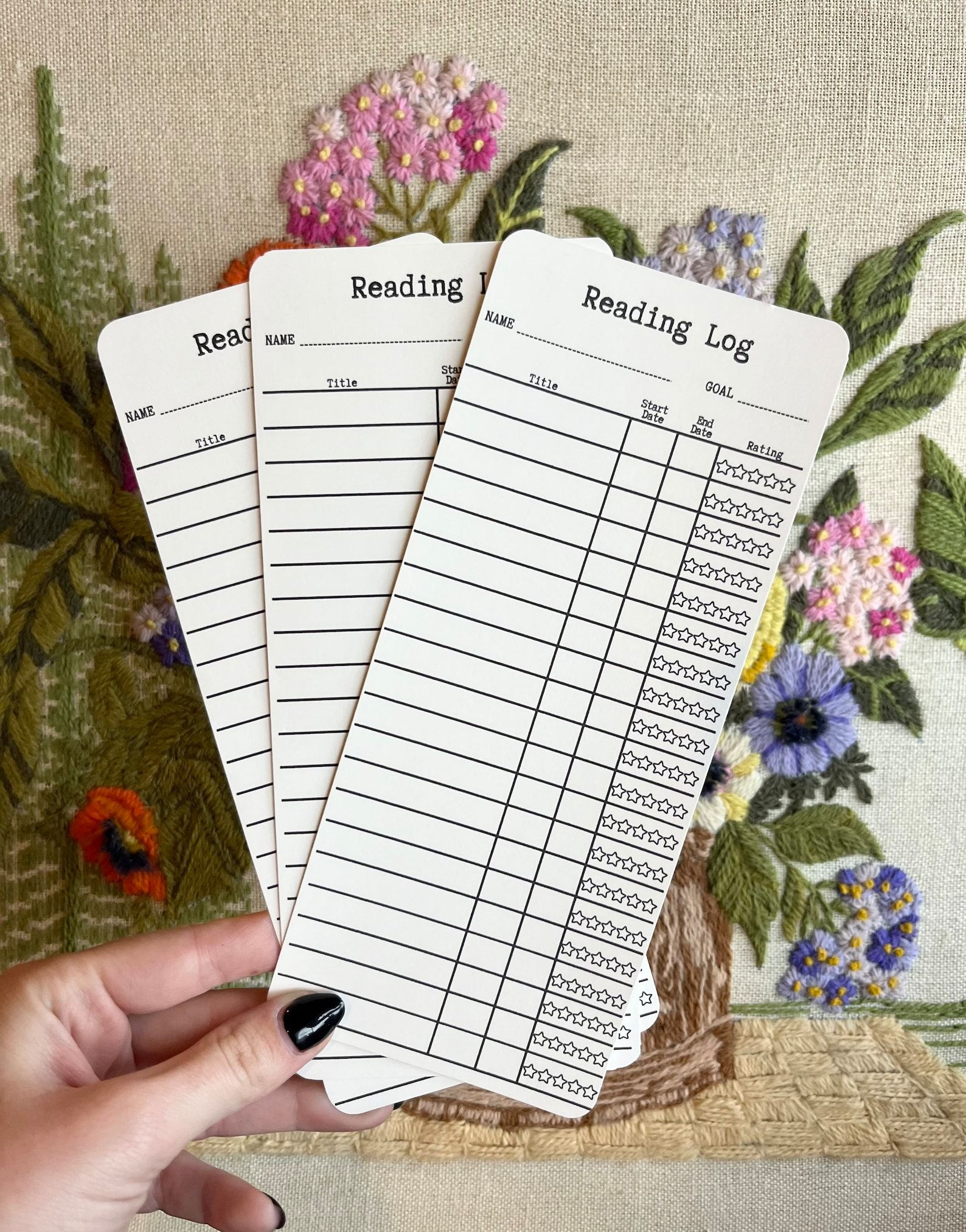 Three bookmarks that have lines for tracking your title, start date, end date, and a star rating.